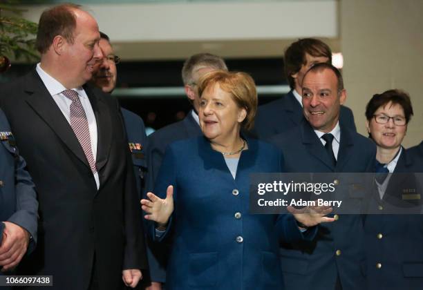 German Chancellor Angela Merkel receives amidst visitors one of the Chancellery's three official Christmas trees next to Minster of the Chancellery...