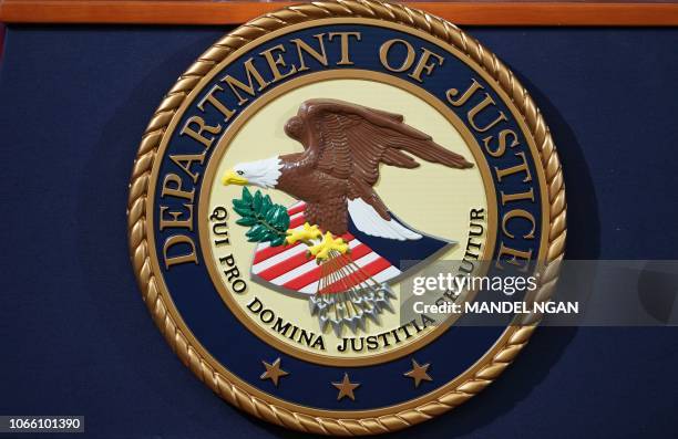 The Department of Justice seal is seen on a lectern ahead of a press conference announcing efforts against computer hacking and extortion at the...