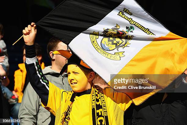 Young Southport fan waves his flag during the FA Cup sponsored by E.ON first Round match between Southport and Sheffield Wednesday at Haig Avenue on...