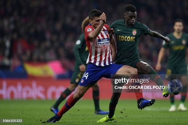 Atletico Madrid's Spanish midfielder Rodri vies with Monaco's French defender Benoit Badiashile during the UEFA Champions League group A football...