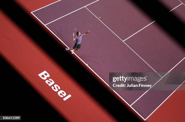 Roger Federer of Switzerland serves to Novak Djokovic of Serbia in the final during Day Seven of the Davidoff Swiss Indoors Tennis at St Jakobshalle...