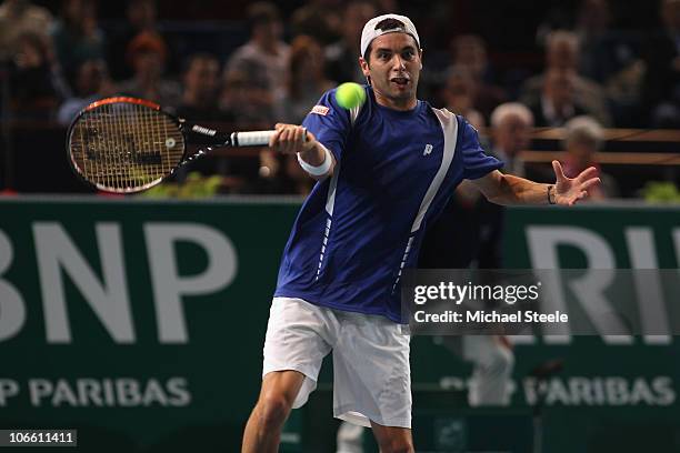 Albert Montanes of Spain returns against Florent Serra of France during Day One of the ATP Masters Series Paris at the Palais Omnisports on November...