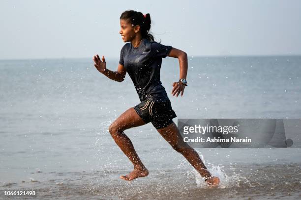 a rugby player works out at the beach - sand art in india stock-fotos und bilder
