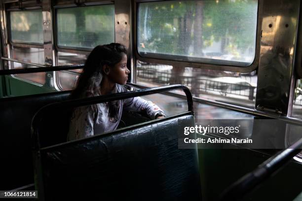 a student rides the bus to her college in mumbai - indian college girl stock pictures, royalty-free photos & images