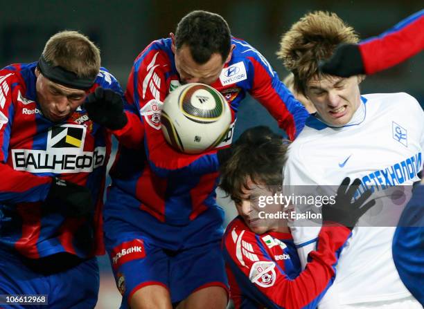 Vasili Berezutski , Sergei Ignashevich and Georgi Schennikov of PFC CSKA Moscow battles for the ball with Oleg Ivanov of FC Krylia Sovetov Samara...
