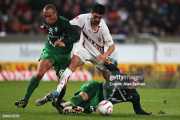 Ciprian Marica of Stuttgart is challenged by Mikael Silvestre and Sebastian Proedl of Bremen during the Bundesliga match between VfB Stuttgart and SV...