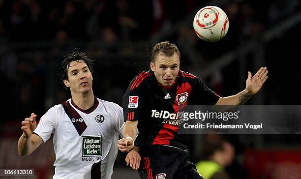 Daniel Schwaab of Leverkusen and Srdan Lakic of Kaiserslautern jump for a header during the Bundesliga match between Bayer Leverkusen and 1. FC...