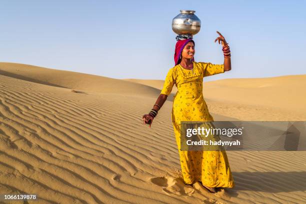 young indian girl carrying water from well, desert village, india - rajasthan dance stock pictures, royalty-free photos & images