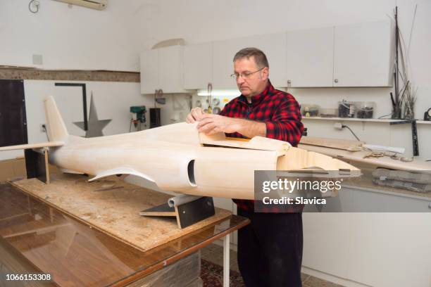 carpenter making airplane model in the workshop - man builds his own plane imagens e fotografias de stock