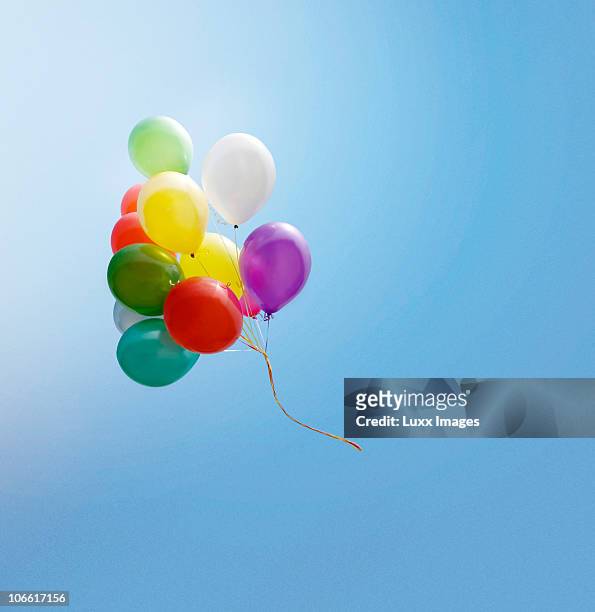 bunch of balloons flying in the blue sky - balloon ストックフォトと画像
