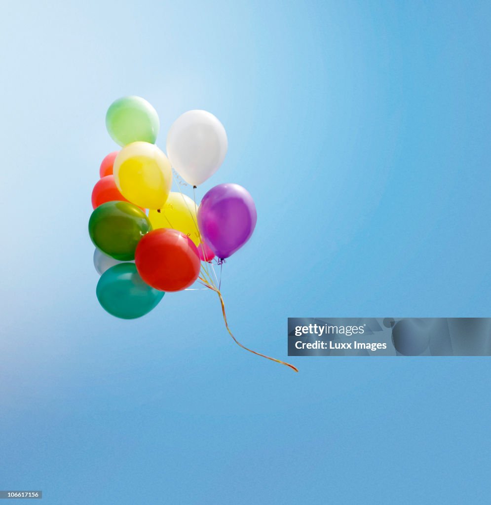 Bunch of balloons flying in the blue sky