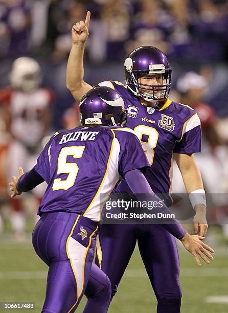 Kicker Ryan Longwell and holder Chris Kluwe of the Minnesota Vikings celebrate their game winning field goal in overtime against the Arizona...