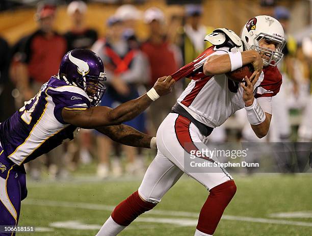 Defensive end Ray Edwards of the Minnesota Vikings grabs the jersey of quarterback Derek Anderson of the Arizona Cardinals at Hubert H. Humphrey...