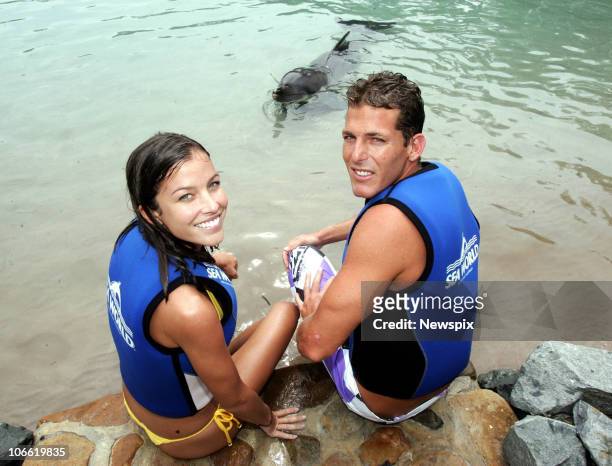 Reigning world surfing champion Andy Irons of the United States of America and girlfriend Lyndie Dupuis swins with dolphins at Sea World on March 17,...