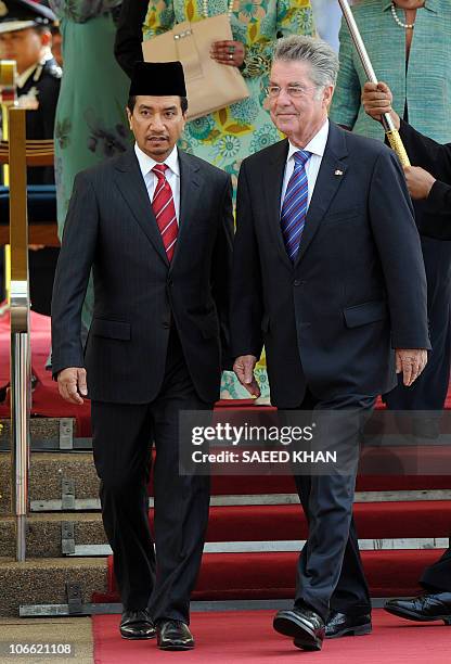 Malaysia's King Sultan Mizan Zainal Abidin and Austrian President Heinz Fischer walk down the stage after a guard of honour ceremony at the...