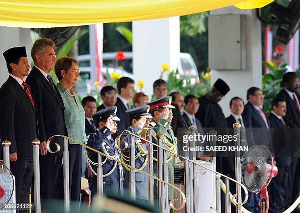 Malaysia's King Sultan Mizan Zainal Abidin along with Austrian President Heinz Fischer and his wife Margit Fischer listen to the national anthems...