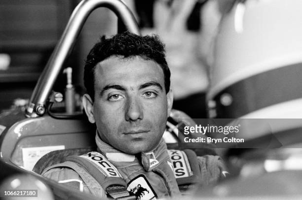 Formula One Grand Prix racing driver Michele Alboreto, driving for Ferrari, sits waiting in his car ahead of competing in a qualifying session for...