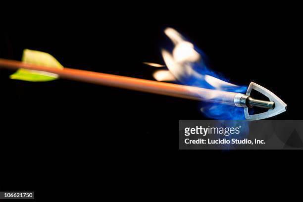 arrow with flames shooting off the tip - bow and arrow stock pictures, royalty-free photos & images