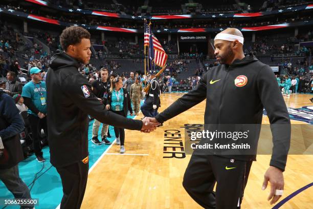 Justin Anderson and Vince Carter of the Atlanta Hawks shake hands before the game against the Charlotte Hornets on November 28, 2018 at the Spectrum...