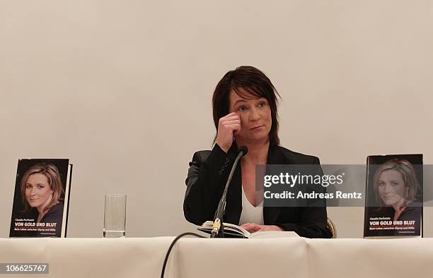 German speed skating champion Claudia Pechstein reacts while she reads in her autobiography 'Of gold and blood - my life between Olympus and hell'...