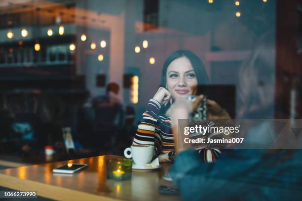 smiling friends enjoying coffee together - cafe culture stock pictures, royalty-free photos & images