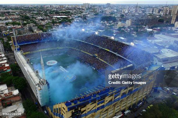 Smoke flares are seen as players walk onto the field before the first leg match between Boca Juniors and River Plate as part of the Finals of Copa...