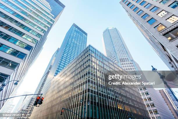 low angle view of modern office buildings skyscrapers in manhattan midtown, new york - bank building stock pictures, royalty-free photos & images