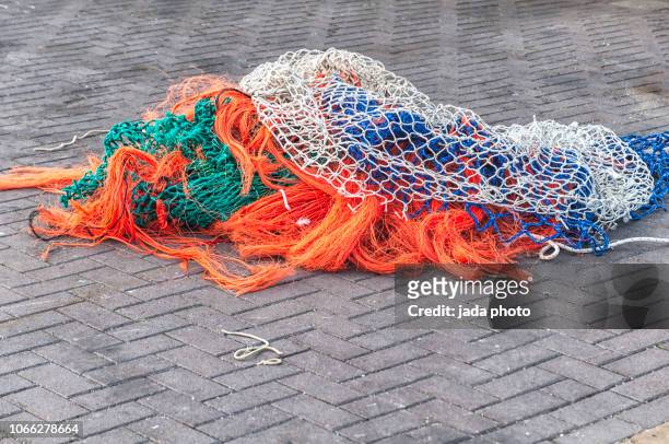 several coloured fishing nets - commercial fishing net fotografías e imágenes de stock