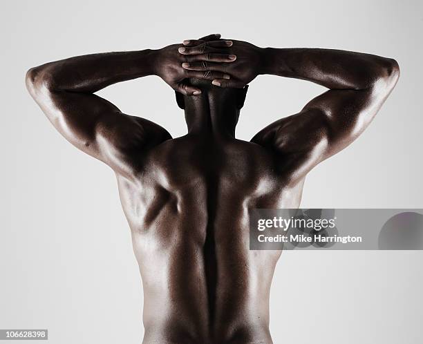 athletic black male showing muscular back - black male bodybuilders stock pictures, royalty-free photos & images