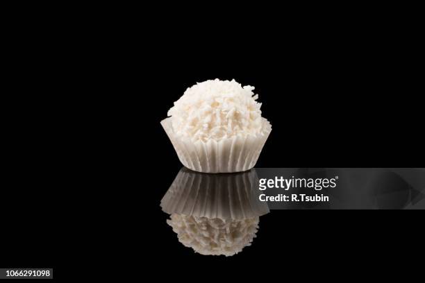 white sweet chocolate, covered the coconut shaving on a dark background - coconut shaving stock pictures, royalty-free photos & images
