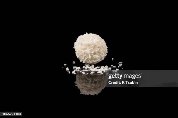 white sweet chocolate, covered the coconut shaving on a dark background - coconut shaving stock pictures, royalty-free photos & images