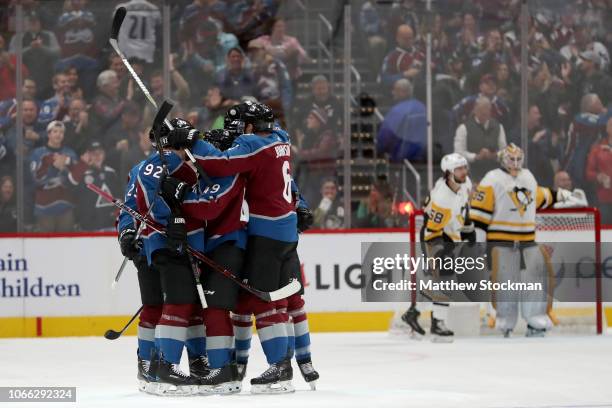 Members of the Colorado Avalanche celebrate a golal by Samuel Girard against the Pittsburgh Penguins in the first period at the Pepsi Center on...