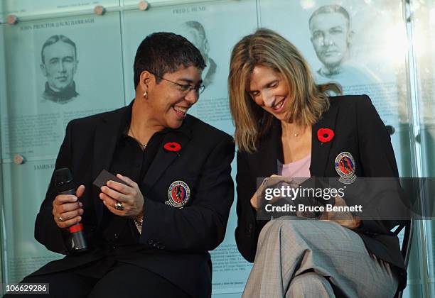 Angela James and Cammi Granato share a moment looking at their new Hall rings at the media opportunity prior to their induction ceremony at the...