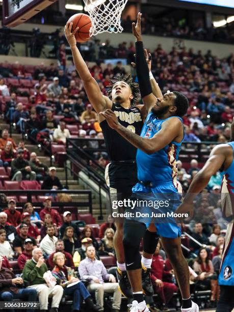 Carsen Edwards of the Purdue Boilermakers attacks the basket over PJ Savoy of the Florida State Seminoles during the ACC-Big Ten Challenge at Donald...