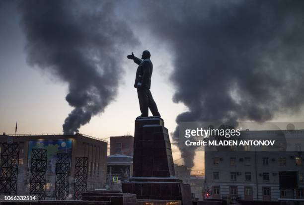Picture taken on November 29, 2018 shows a monument to the Soviet Union founder Vladimir Lenin on the main square of the eastern Siberian city of...