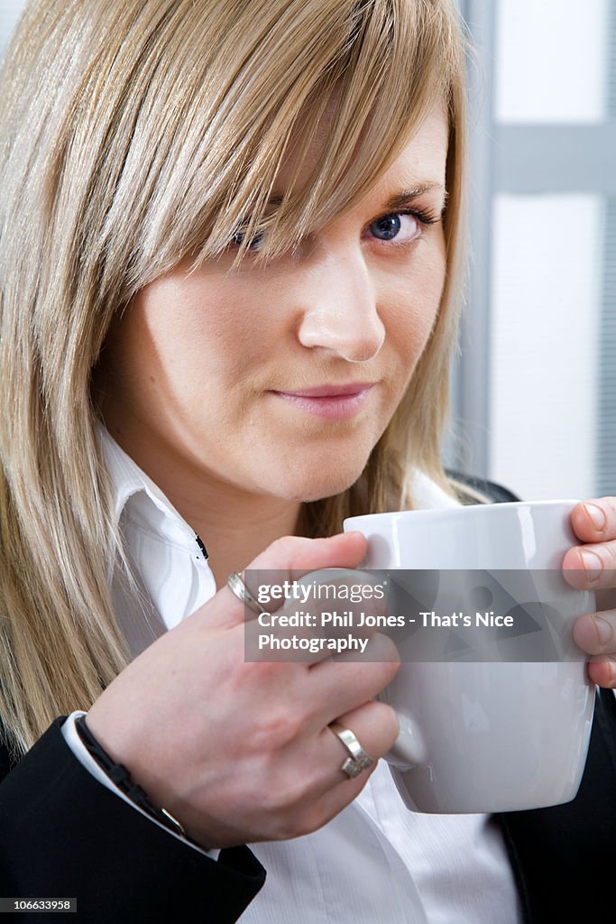 Young businesswoman holding mug
