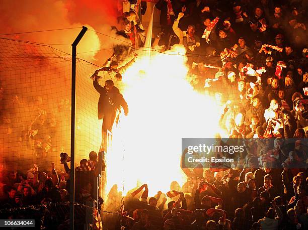 Fans light flares during the Russian Football League Championship match between FC Rubin Kazan and FC Spartak Moscow at the Tsentraliniy Stadium on...