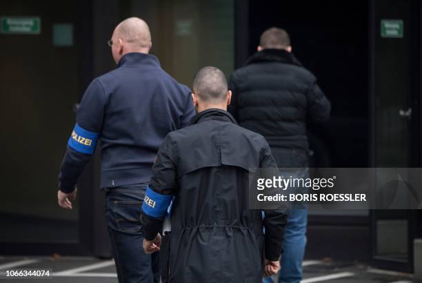 Civilian police investigators enter Deutsche Bank's headquarters in Frankfurt on November 29, 2018. - German prosecutors raided several Deutsche Bank...