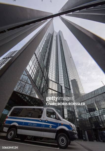 Police vehicle is parked at Deutsche Bank's headquarters in Frankfurt on November 29, 2018. - German prosecutors raided several Deutsche Bank offices...