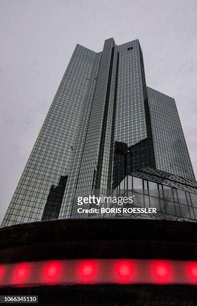 Red illuminated bollard is pictured in front of Deutsche Bank's headquarters in Frankfurt on November 29, 2018. - German prosecutors raided several...