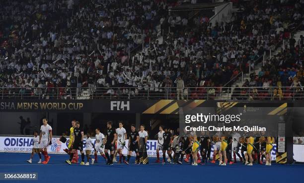 The New Zealand and France teams make their way onto the field during the FIH Men's Hockey World Cup Pool A match between New Zealand and France at...