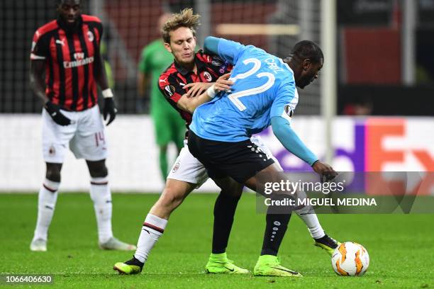 Milan's Croatian forward Alen Halilovic and F91 Dudelange's Angolan midfielder Stelvio go for the ball during the UEFA Europa League group F football...