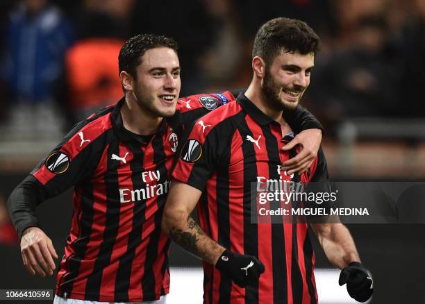 Milan's Italian forward Patrick Cutrone celebrates with AC Milan's Italian defender Davide Calabria celebrates after opening the scoring during the...