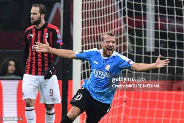 Dudelange's German midfielder Dominik Stolz celebrates adter scoring an equalizer as AC Milan's Argentine forward Gonzalo Higuain reacts during the...
