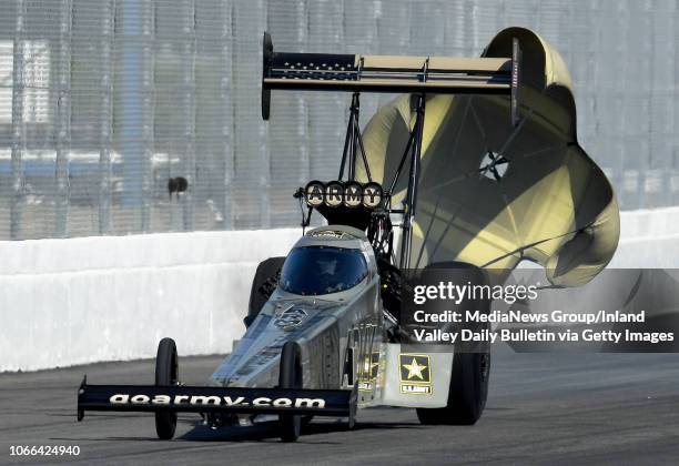 Top Fuel driver Tony Schumacher pulls his parachutes during the first round of eliminations in Pomona on Sunday, November 11, 2018 at the 54th annual...
