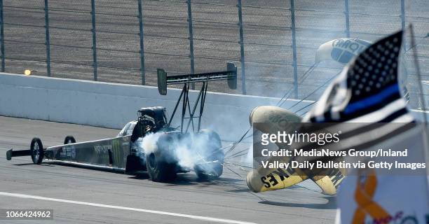 Top Fuel driver Brittany Force heads through the shutdown area after defeating Antron Brown during the quarterfinal round of eliminations in Pomona...