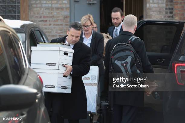 People believed to be federal agents remove computer equipment and document boxes from the Southside office of 14th Ward Alderman Ed Burke on...