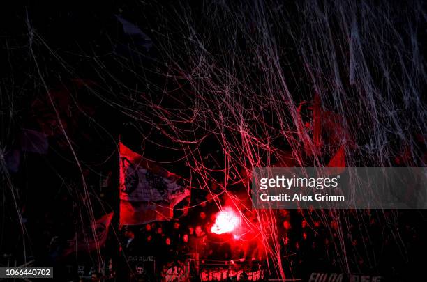 Fan holds up a flare during the UEFA Europa League Group H match between Eintracht Frankfurt and Olympique de Marseille at Commerzbank-Arena on...