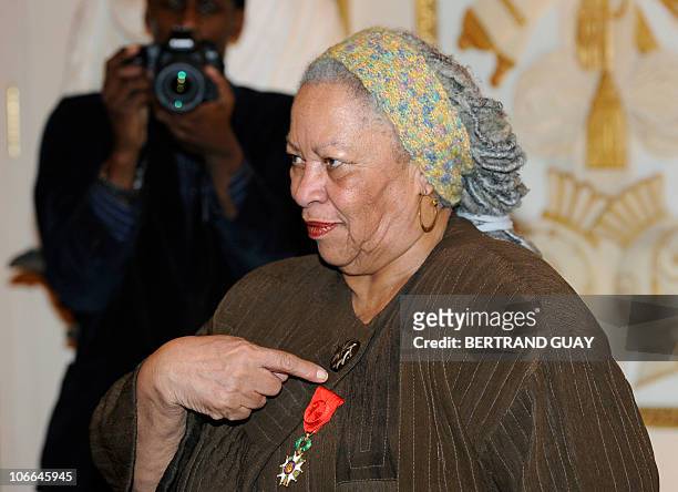 Nobel and Pulitzer prize winning US novelist, editor and professor Toni Morrison points to her medal after being awarded the Legion of Honour on...