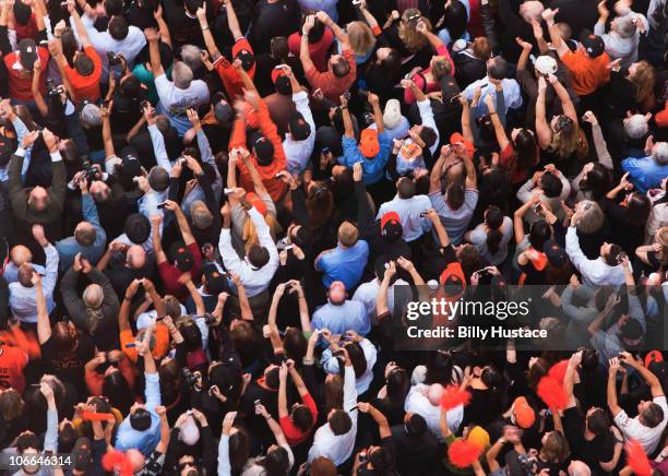 crowd at a victory parade holding mobile phones. - baseball crowd stock-fotos und bilder